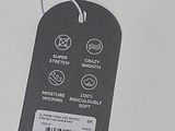 a tag on a computer mouse that is on a desk