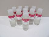 six bottles of hand sanitizer sitting on a white surface