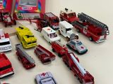 a lot of toy fire trucks and cars on the table