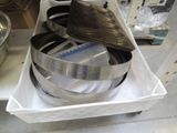 a stack of pans sitting on a cart in a kitchen