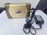 a gold case and a charger on a white table
