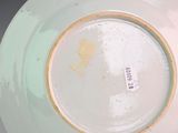 a white plate with a yellow rim on a table