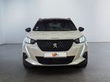 the front view of a white car in a white room
