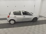 a picture of a small white car parked in a garage