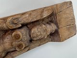 a piece of wood with carvings on it on the wall
