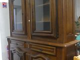 an image of a wooden china cabinet in a room