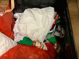 many bags and bags of clothing in a bin