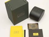 a black box with a watch and a yellow box with a black watch