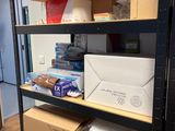 boxes and boxes are stacked on a shelf in a room