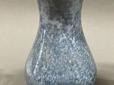 a blue and white vase sitting on a table