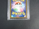 the pokemon trading card is in a plastic holder on a table