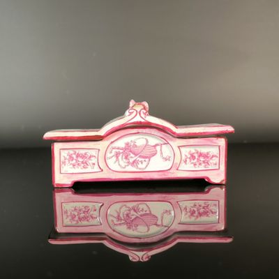 a pink and white box on a black table