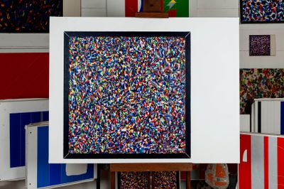 brightly colored sprinkles are displayed in a white frame in a room