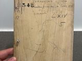 a person holding a piece of wood with a drawing on it