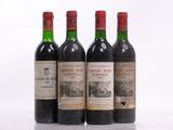 three bottles of red wine sitting on top of a white table