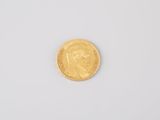 a close up of a gold coin on a white surface
