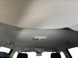 the back of a car with the sunroof down and the passenger seat down