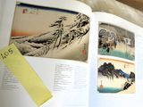 an open book with a picture of a mountain in it