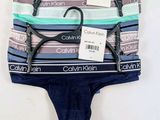 three pairs of underwear are hanging on a hanger on a wall