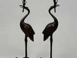 pair of bronze candlesticks with birds and flowers on them