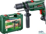 a drill with a green case and a red handle