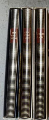 four books are lined up in a row on a table