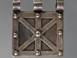 a close up of a metal object on a gray surface