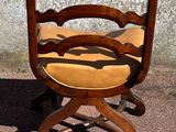 a wooden chair that has a yellow seat on it