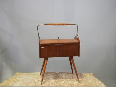 une vieille boîte en bois munie d'une poignée, posée sur un rocher