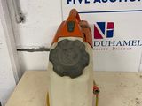 an orange and white vacuum cleaner sitting on top of a table