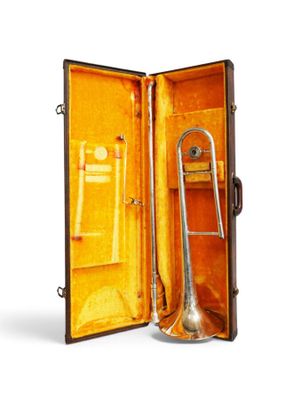 a trumpet in a case that is open on a white background