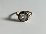 a close up of a gold ring with a coin on it