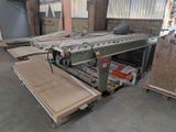 a machine that is working on a piece of wood