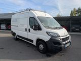 the white van is parked in a parking lot near a building