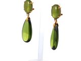 pair of green and gold earrings on a clear stand