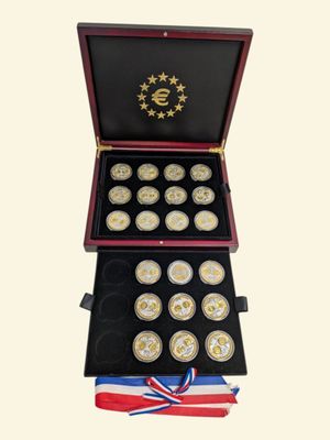 a wooden box with twelve gold coins in it