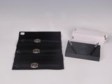 a black wallet and a white wallet on a white table