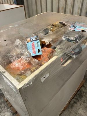 a box of food sitting on a pallet in a room