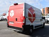 a red and white delivery truck parked in a parking lot