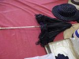 a hat, umbrella, gloves, and other items laid out on a table
