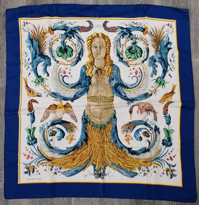 a blue and yellow scarf with a picture of a woman and birds on it