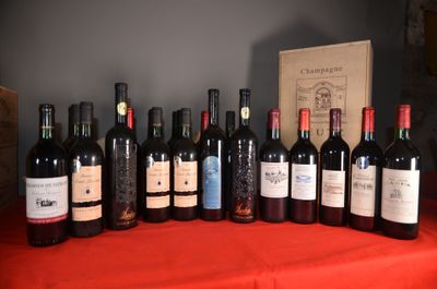 many bottles of wine sitting on a table with a red cloth