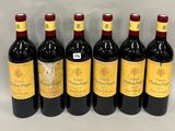 six bottles of red wine lined up in a row on a table