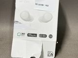 a white box with ear buds in it sitting on a table
