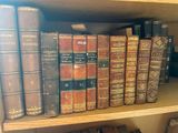 many old books on a wooden shelf in a library