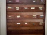 an image of a wooden shelf with lots of boxes on it