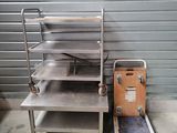 a metal shelf with a metal tray on top of it