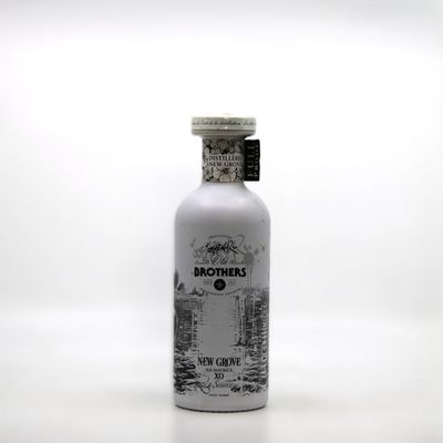 the bottle is full of a white liquid with a black and white drawing on it