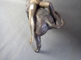 a bronze statue of a woman riding on an elephant