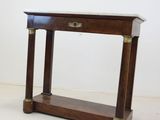 a small wooden table with a marble top on it